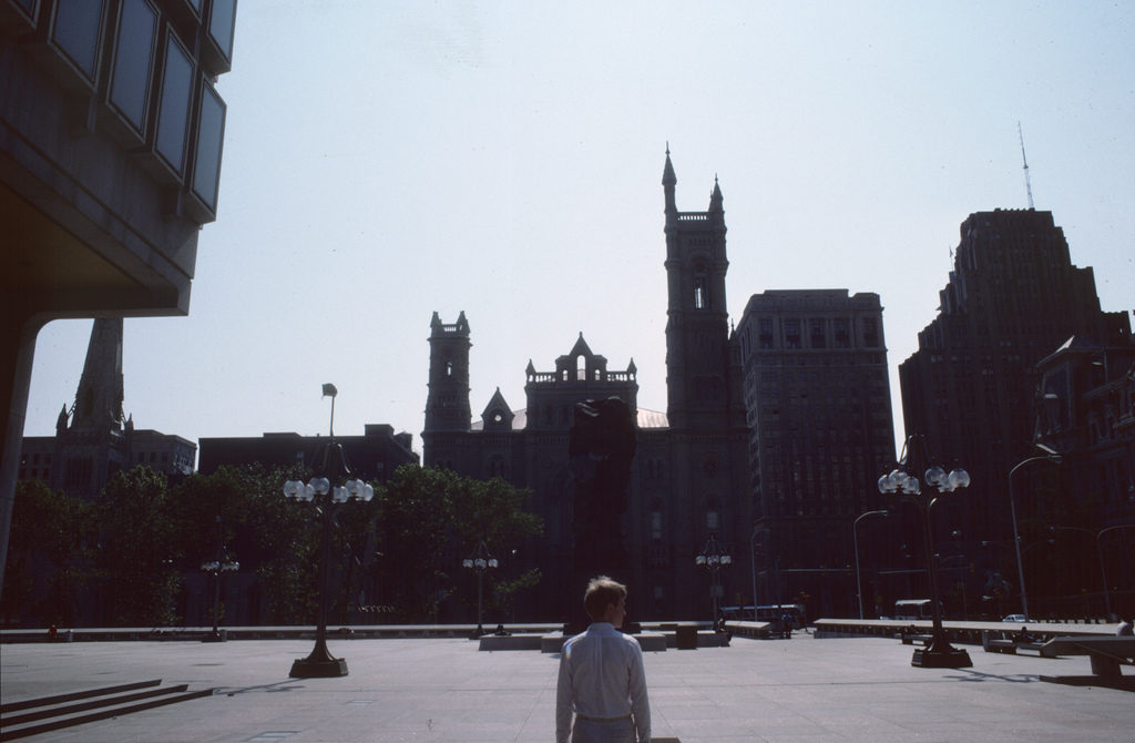 The man in white strolling through Thomas Paine Plaza.