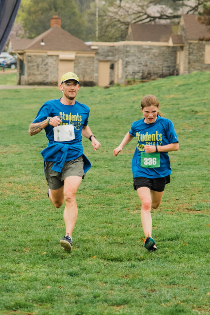 Two Students Run Philly Style participants on the race course. Photo by Heather McBride.