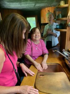 Two visitors on a tour of the Wharton Esherick house explore the copper sink with its inset wooden chopping board. Katherine Allen stands behind them, at right. Photo courtesy of Philly Touch Tours.